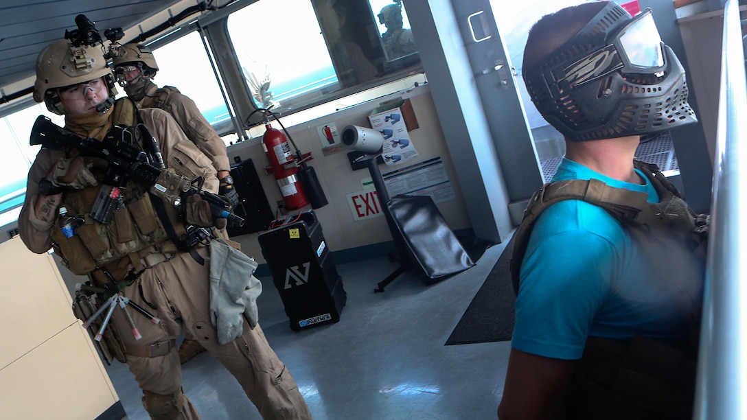 A U.S. Marine with Force Reconnaissance Platoon, Maritime Raid Force, 26th Marine Expeditionary Unit (MEU), provides over-watch on a simulated detainee while conducting visit, board, search and seizure training during an Amphibious Ready Group/Marine Expeditionary Unit Exercise (ARG/MEU-Ex) aboard the USNS Robert E. Peary June 19, 2015. Marines and sailors with the 26th MEU and Amphibious Squadron 4 are conducting an ARG/MEU-Ex in preparation for their deployment to the 5th and 6th Fleet areas of responsibility later this year.