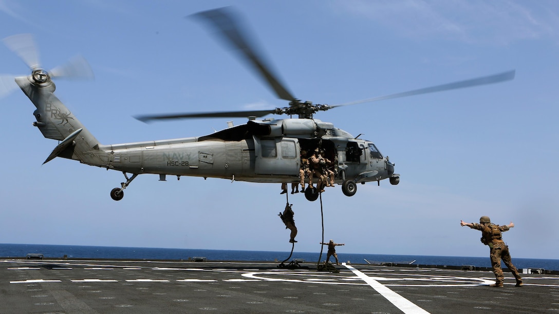 U.S. Marines with Force Reconnaissance Platoon, Maritime Raid Force, 26th Marine Expeditionary Unit (MEU), fast rope from a SH-60 Seahawk with Amphibious Squadron (PHIBRON) 4 while conducting visit, board, search and seizure training during an Amphibious Ready Group/Marine Expeditionary Unit Exercise (ARG/MEU-Ex) aboard the USNS Robert E. Peary June 19, 2015. Marines and sailors with the 26th MEU and PHIBRON 4 are conducting an ARG/MEU-Ex in preparation for their deployment to the 5th and 6th Fleet areas of responsibility later this year. 