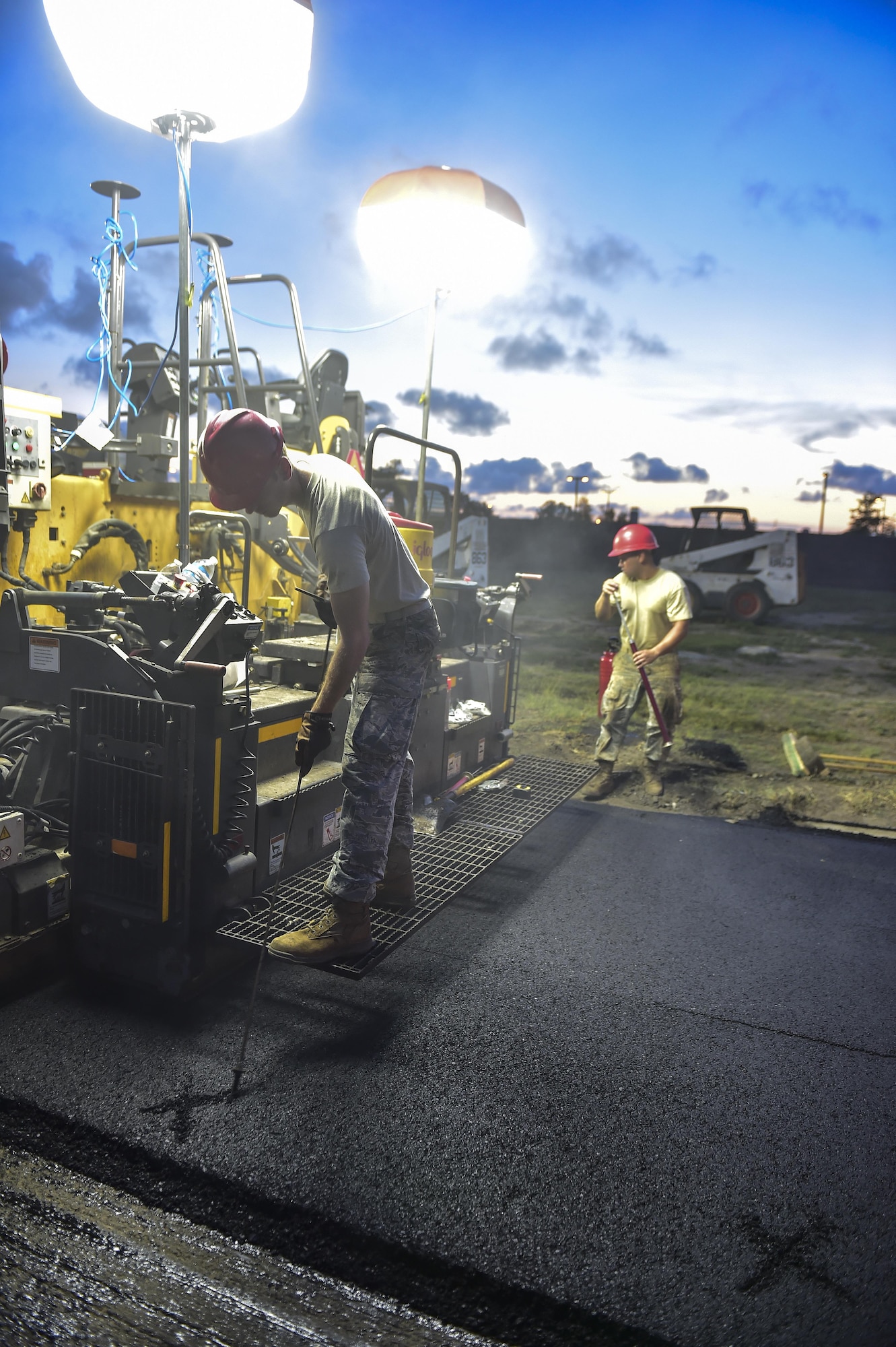 Senior Airman Alex Meredith, 823rd RED HORSE Squadron pavements and construction equipment journeyman, measures and marks holes in the asphalt during a road re-construction project at Hurlburt Field, Fl., June 16, 2015. The re-construction project repaired multiple pot holes and cracks on Independence Road caused by pooling water. (U.S. Air Force photo/Senior Airman Jeff Parkinson)