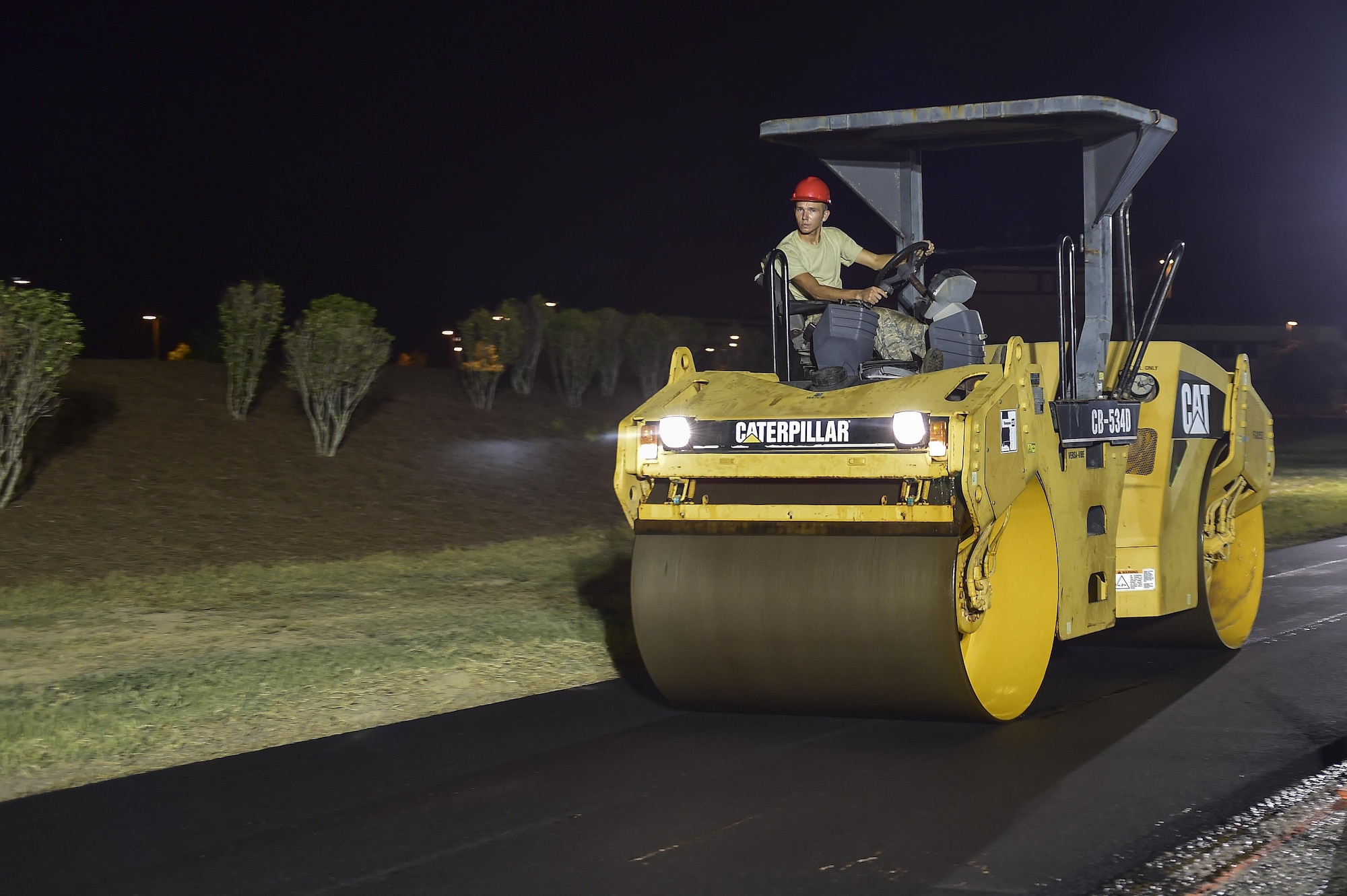 Airman 1st Class Bryan Daniel, 823rd RED HORSE Squadron pavements and construction equipment journeyman, operates a smooth drum roller while paving a portion of Independence Road at Hurlburt Field, Fl., June 16, 2015. The re-construction project repaired multiple pot holes and cracks caused by pooling water. (U.S. Air Force photo/Senior Airman Jeff Parkinson)