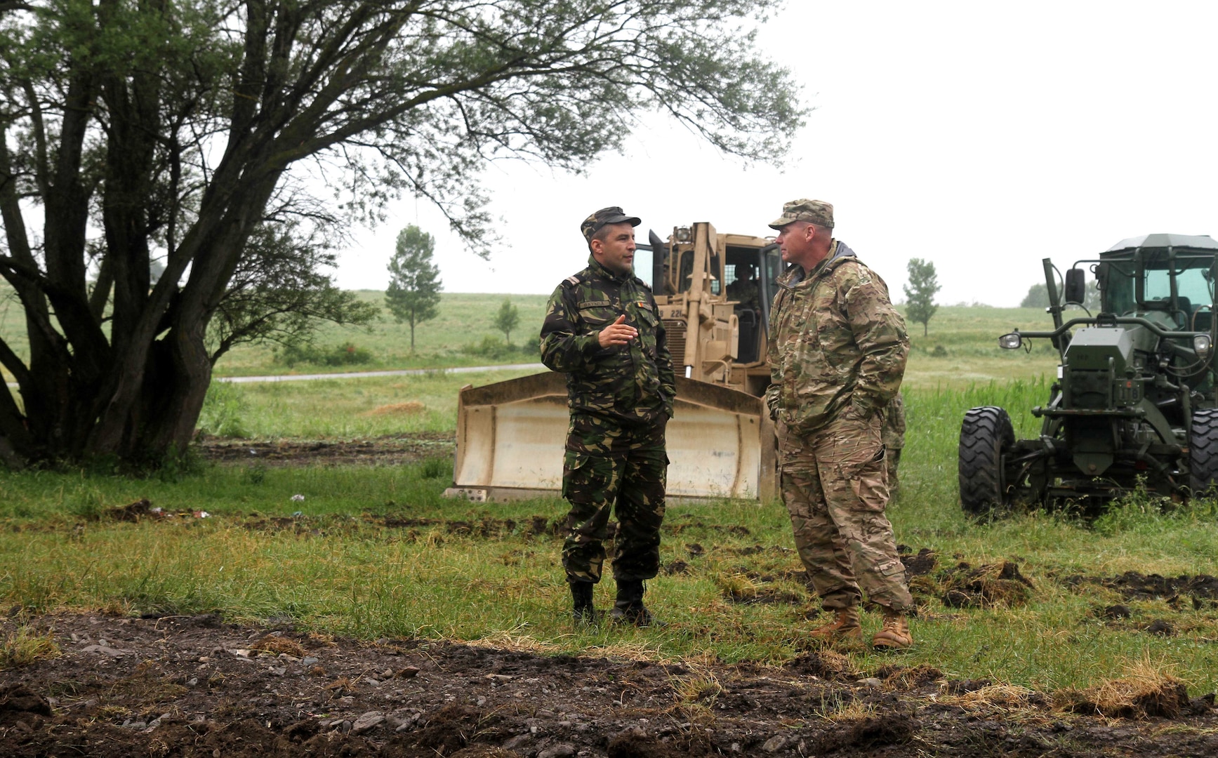 Soldiers with the Alabama National Guard and the Romanian Army break ground on June 16, 2015, as part of Operation Resolute Castle 15. This operation is a collaborative effort to create roads and buildings for military use in the Cincu Training Center.