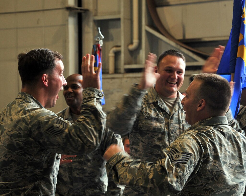 U.S. Air Force Airmen from the 72nd Aerial Port Squadron react to be being announced as the 2015 Port Dawg Challenge champions at Dobbins Air Reserve Base, Ga., June 18, 2015. The Port Dawg Challenge was created to enhance and maintain the camaraderie, espirt de corp and prestige of Aerial Port Airmen while promoting professionalism, leadership, training and communication between "Port Dawgs."(U.S. Air Force photo by Senior Airman Josh Slavin/Released)