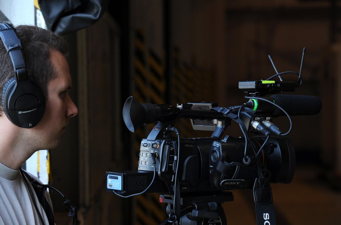 U.S. Air Force Senior Airman Joshua Roberts, 4th Combat Camera Squadron broadcaster, documents participants during the Port Dawg Challenge at Dobbins Air Reserve Base, Ga., June 18, 2015. The Port Dawg Challenge was created to enhance and maintain the camaraderie, esprit de corps and prestige of Aerial Port Airmen while promoting professionalism, leadership, training and communication between "Port Dawgs." (U.S. Air Force photo by Tech. Sgt. Stephen D. Schester/Released)