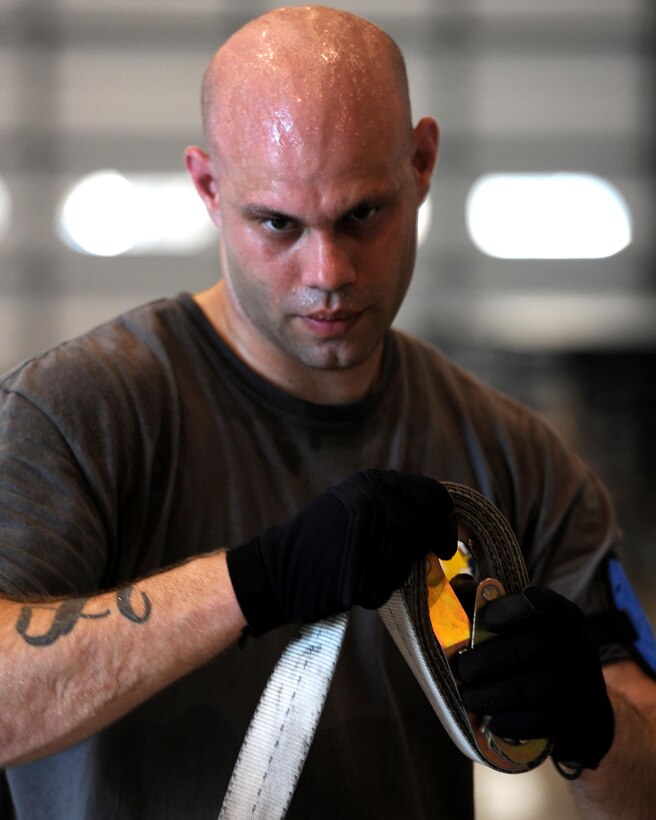 U.S. Air Force Tech. Sgt. John Carmack, 86th Aerial Port Squadron, rolls up pallet straps during the Pallet Build-Up competition of the Port Dawg Challenge at Dobbins Air Reserve Base, Ga., June 18, 2015. The Port Dawg Challenge was created to enhance and maintain the camaraderie, esprit de corps and prestige of Aerial Port Airmen while promoting professionalism, leadership, training and communication between "Port Dawgs." (U.S. Air Force photo by Tech. Sgt. Stephen D. Schester/Released)