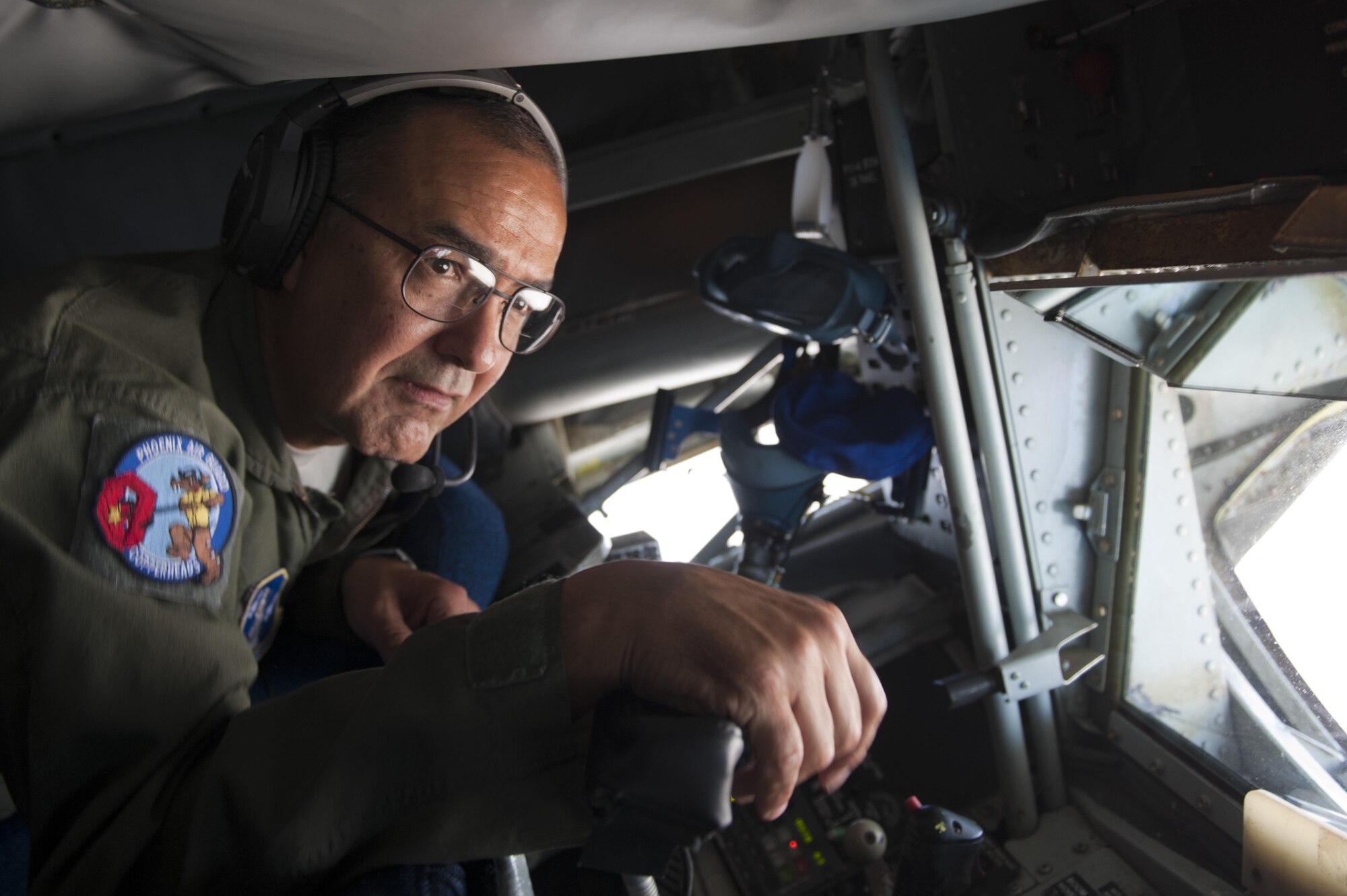 Chief Master Sgt. Carlos Trujillo, 161st Air Refueling Wing boom operator, Arizona Air National Guard, prepares to refuel 61st Fighter Squadron F-35 Lightning IIs, June 5, 2015. Air-to-air refueling allows pilots to extend the combat radius of their aircraft. (U.S. Air Force photo by Staff Sgt. Staci Miller)
