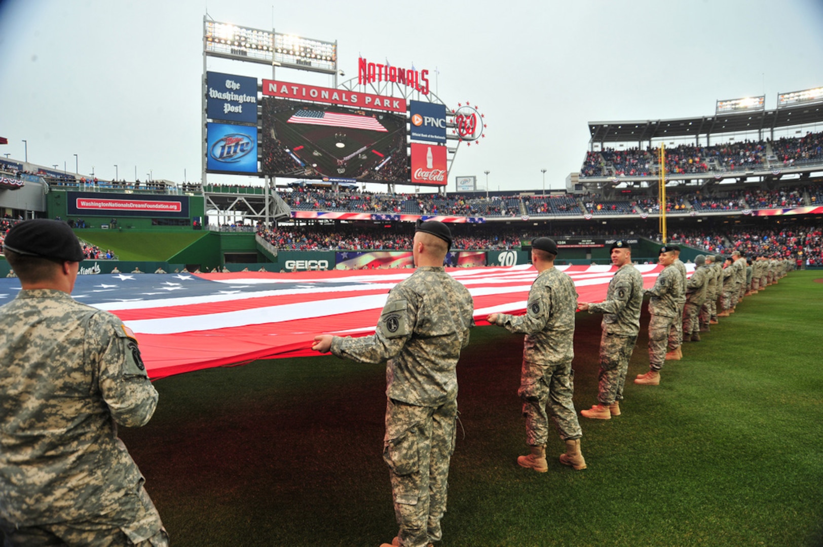 Members of the D.C. National Guard hold a football-field sized American flag on the outfield during pre-game ceremonies for Opening Day at Nationals Park in Washington, D.C. March 31, 2011.