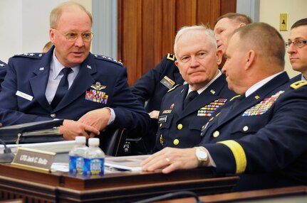 Air Force Gen. Craig McKinley speaks with Army Lt. Gen. Jack Stultz, commanding general, U.S. Army Reserve Command and Army Maj. Gen. Raymond Carpenter, acting director Army National Guard, before they testified to the House Appropriations Subcommittee on Defense, March 30, 2011. The senior leaders spoke to the necessity of keeping the Reserve components as the fully operational forces they have become instead of the strategic Reserves they were after the Cold War.