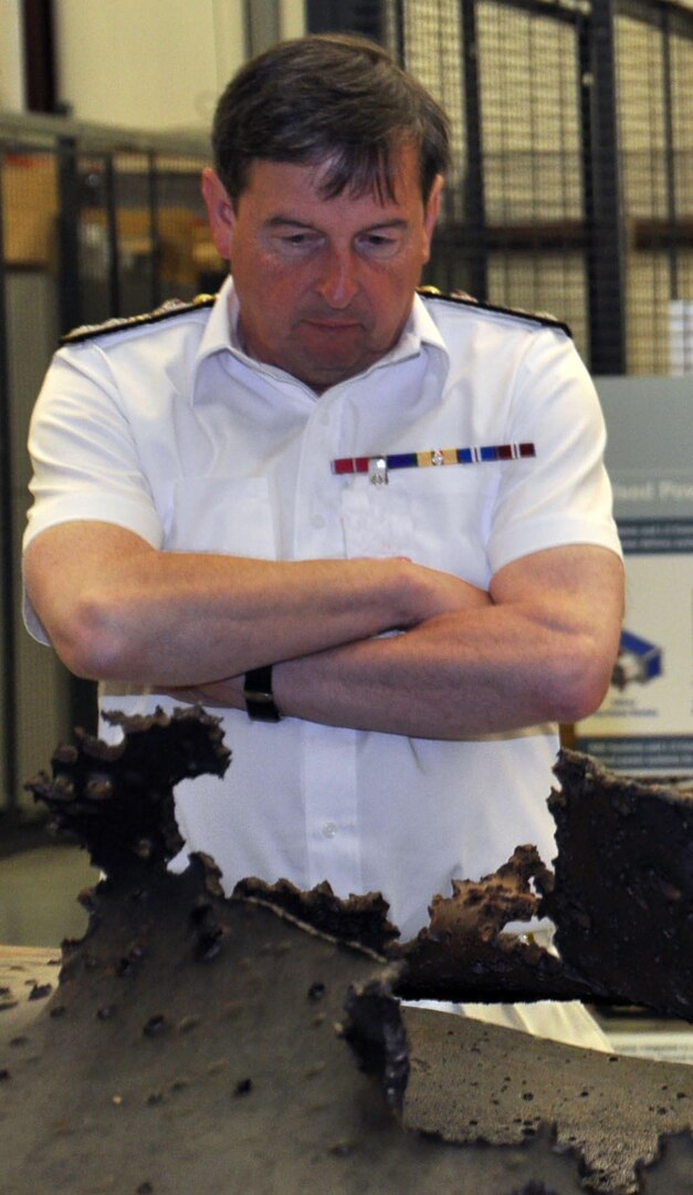 UK Royal Navy Second Sea Lord Vice Adm. Jonathan Woodcock examines the damage caused by a hypervelocity projectile during a visit to the Naval Surface Warfare Center Dahlgren Division (NSWCDD) Electromagnetic Railgun facility June 10. The hypervelocity projectile is a next-generation, guided projectile capable of completing multiple missions for gun systems such as the Navy 5-Inch, 155-mm, and future railguns. The second sea lord - responsible for the delivery of the British naval service's current and future personnel, equipment and infrastructure - visited NSWCDD with his delegation of British military officials for briefings on the command's technological programs and testing facilities. "Our Electromagnetic Railgun Program began in cooperation with the UK - leveraging development work they had already done - giving us the footing to develop a program at a much further advanced state today," said Jed Ryan,  NSWCDD International Partnering Office lead. "We are also excited about newer areas of existing or potential collaboration, such as directed energy weapons programs that include radio frequency and high energy lasers."
