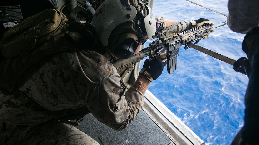 A U.S. Marine with the 15th Marine Expeditionary Unit’s Maritime Raid Force practices aerial sniping from a CH-53E Super Stallion. The Marines practiced shooting at floating targets in order to improve their marksmanship and become comfortable firing from the air. The 15th MEU is embarked on the Essex Amphibious Ready Group and deployed to maintain regional security in the U.S. 5th Fleet area of operations. 