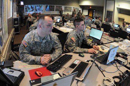 Staff Sgt. Nick Suko, left and Sgt. Justin Valenti are members of the North
Dakota National Guard Joint Task Force East participating in flood-fighting
operations April 6, 2011, at the North Dakota Air National Guard, Fargo,
N.D. The high-tech flood-fighting operations center is being manned 24-hours
per day until it is no longer necessary.