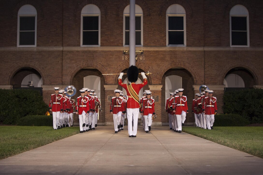 Marines with the United States Marine Band perform during the evening parade at Marine Barracks Washington, D.C., June 19, 2015. Retired U.S. Marine Corps Lt. Gen. Robert M. Shea, chairman of the Board of Directors, Marine Corps Toys for Tots Foundation, was the guest of honor for the parade and Lt. Gen. Richard P. Mills, commander, Marine Forces Reserve and Marine Forces North, was the hosting official for that same parade. The Evening Parade summer tradition began in 1934 and features the Silent Drill Platoon, the U.S. Marine Band, the U.S. Marine Drum and Bugle Corps and two marching companies. More than 3,500 guests attend the parade every week. (U.S. Marine Corps Photo by Lance Cpl. Hailey D. Stuart/Released)