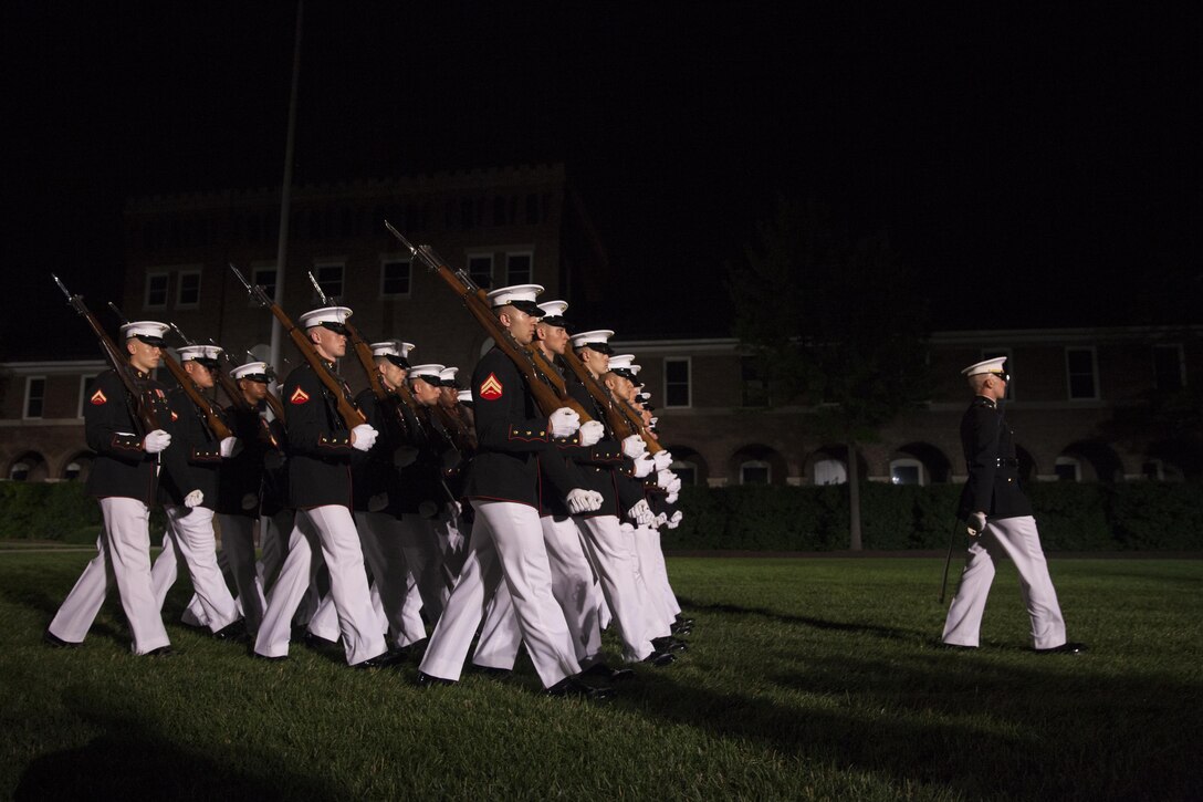 Marines with Marine Barracks Washington D.C. march pass in review during the evening parade, June 19, 2015. Retired U.S. Marine Corps Lt. Gen. Robert M. Shea, chairman of the Board of Directors, Marine Corps Toys for Tots Foundation, was the guest of honor for the parade and Lt. Gen. Richard P. Mills, commander, Marine Forces Reserve and Marine Forces North, was the hosting official for that same parade. The Evening Parade summer tradition began in 1934 and features the Silent Drill Platoon, the U.S. Marine Band, the U.S. Marine Drum and Bugle Corps and two marching companies. More than 3,500 guests attend the parade every week. (U.S. Marine Corps Photo by Lance Cpl. Hailey D. Stuart/Released)
