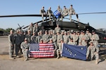 Alaska Army National Guard members from B Co., 1-207th Aviation, pose for a 
group photo next to a UH-60 Black Hawk helicopter in Iraq. The "Arctic Cowboys" transport distinguished visitors, Soldiers and equipment from camp 
to camp, ensuring their safety and assisting in the completion of valuable 
missions.