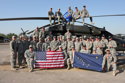 Alaska Army National Guard members from B Co., 1-207th Aviation, pose for a 
group photo next to a UH-60 Black Hawk helicopter in Iraq. The "Arctic Cowboys" transport distinguished visitors, Soldiers and equipment from camp 
to camp, ensuring their safety and assisting in the completion of valuable 
missions.