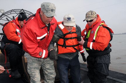 Capt. Grant Larson, of the 119th Maintenance Squadron, left, and Tom Hall, a
Cass County Sherriff’s deputy, assist 87-year-old Obert Tenold to his feet
April 9, 2011, as Tenold is helped out of a Cass County Otter Team airboat
near Harwood, N.D. A joint government agency team is evacuating Tenold from
his home, at his request, as floodwater surrounds his residence, making it
impossible for him to get out on his own. The team is an example of how
agencies are working together to help others during the 2011 Red River
Valley flood. As of Saturday April 9, about 480 N.D. Air and Army Guardsmen
were conducting flood operations.