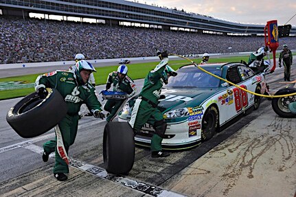 The pit crew of Dale Earnhardt Jr.,driver of the No. 88 National Guard NASCAR racecar, feverishly works to get their car and driver out of pit road, at the Texas Motor Speedway in Fort Worth, Texas., April 9, 2011. The ninth-place finish netted by Earnhardt moved him up into the sixth position in the championship standings.