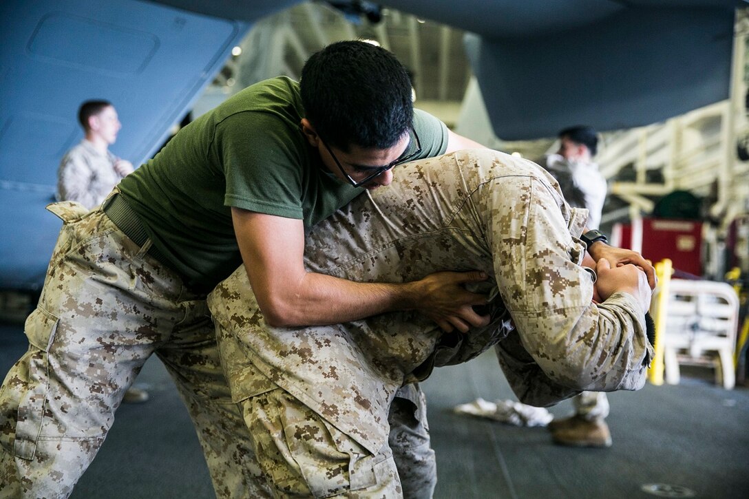 U.S. Marines with Lima Company, Battalion Landing Team 3rd Battalion, 1st Marine Regiment, 15th Marine Expeditionary Unit, practice detainee-handling techniques aboard the USS Essex (LHD 2) in the Indian Ocean, June 19, 2015. These Marines practiced conducting thorough searches on suspected threats. (U.S. Marine Corps photo by Cpl. Anna Albrecht/Released)