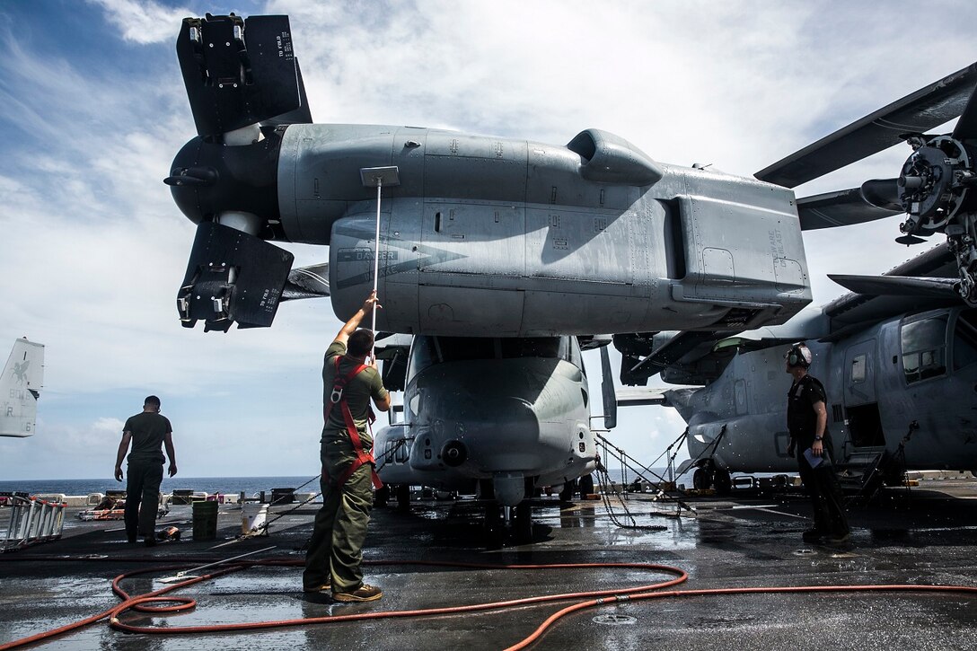 U.S. Marines with Marine Medium Tiltrotor Squadron 161 (Reinforced), 15th Marine Expeditionary Unit, wash an MV-22B Osprey on the flight deck of the USS Essex (LHD 2) in the Indian Ocean, June 20, 2015. These Marines keep their aircraft clean to ensure they are in the best condition possible and are ready to fly at a moment’s notice. (U.S. Marine Corps photo by Cpl. Anna Albrecht/Released)