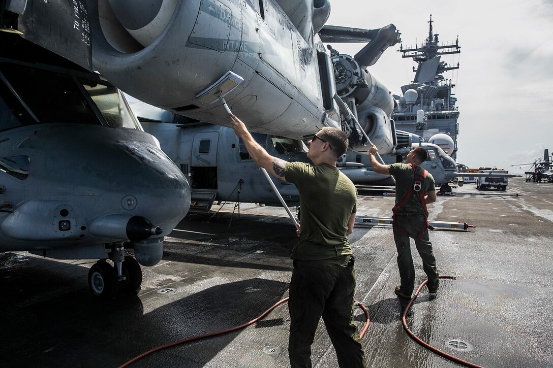 U.S. Marines with Marine Medium Tiltrotor Squadron 161 (Reinforced), 15th Marine Expeditionary Unit, wash an MV-22B Osprey on the flight deck of the USS Essex (LHD 2) in the Indian Ocean, June 20, 2015. These Marines keep their aircraft clean to ensure they are in the best condition possible and are ready to fly at a moment’s notice. (U.S. Marine Corps photo by Cpl. Anna Albrecht/Released)