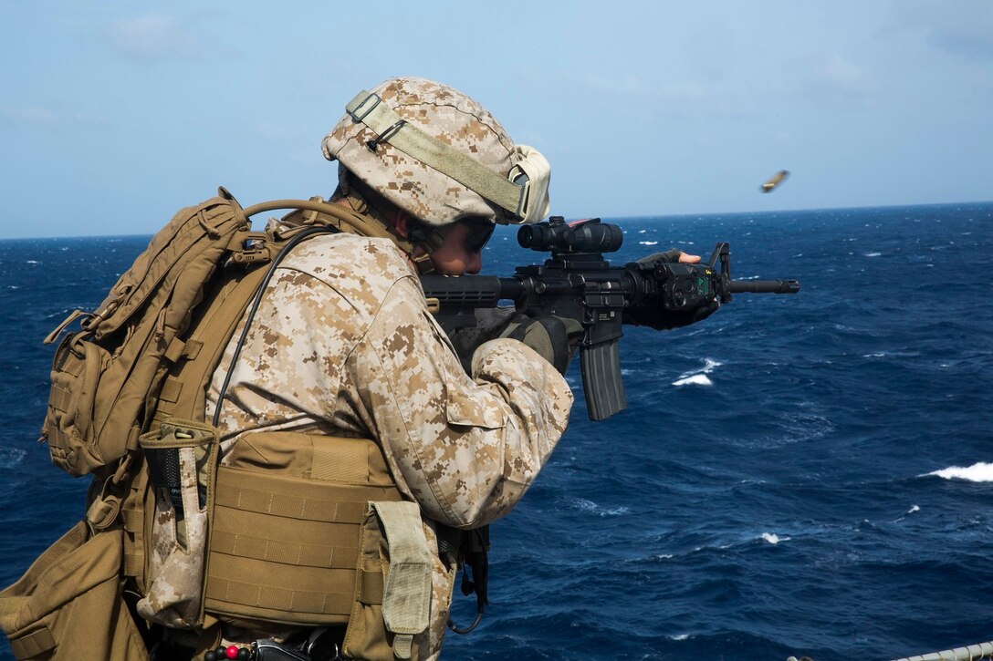150621-M-SV584-015 ARABIAN SEA (June 21, 2015) A U.S. Marine with the 15th Marine Expeditionary Unit practices marksmanship on the flight deck aboard the amphibious assault ship USS Essex (LHD 2). These Marines executed a variety of drills, including slow-fire, during which they were able to focus on their shooting stance and the different off-sets they need to apply as they move closer to their targets. The 15th MEU is embarked on the Essex Amphibious Ready Group and deployed to maintain regional security in the U.S. 5th Fleet area of operations. (U.S. Marine Corps photo by Cpl. Anna Albrecht/Released)