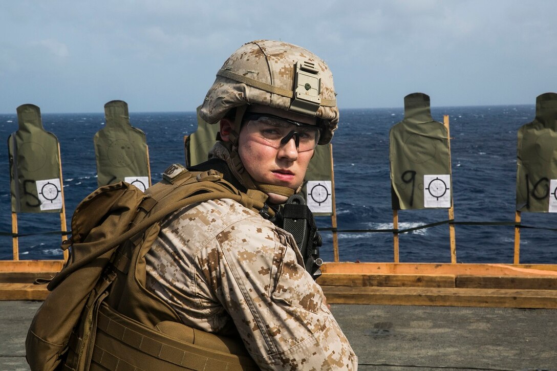 150621-M-SV584-035 ARABIAN SEA (June 21, 2015) A U.S. Marine with the 15th Marine Expeditionary Unit practices marksmanship on the flight deck aboard the amphibious assault ship USS Essex (LHD 2). These Marines focused on improving their speed and accuracy while shooting. The 15th MEU is embarked on the Essex Amphibious Ready Group and deployed to maintain regional security in the U.S. 5th Fleet area of operations. (U.S. Marine Corps photo by Cpl. Anna Albrecht/Released)