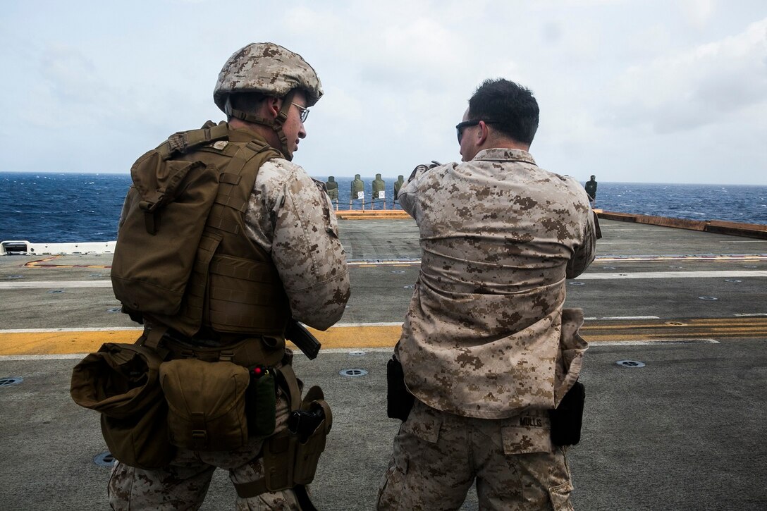 150621-M-SV584-013 ARABIAN SEA (June 21, 2015) U.S. Marines with the 15th Marine Expeditionary Unit practice marksmanship on the flight deck aboard the amphibious assault ship USS Essex (LHD 2). These Marines executed a variety of drills, including slow-fire, during which they were able to focus on their shooting stance and the different off-sets they need to apply as they move closer to their targets. The 15th MEU is embarked on the Essex Amphibious Ready Group and deployed to maintain regional security in the U.S. 5th Fleet area of operations. (U.S. Marine Corps photo by Cpl. Anna Albrecht/Released)