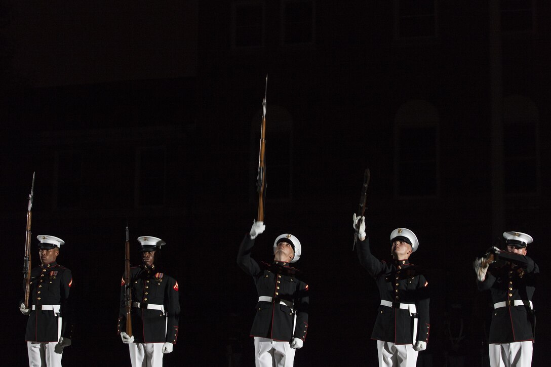 Marines with Marine Barracks Washington, D.C., perform during a Friday Evening Parade, June 19, 2015. Retired Lt. Gen. Robert M. Shea, chairman of the board of directors, Marine Toys for Tots Foundation, was the guest of honor, and Lt. Gen. Richard P. Mills, commander, Marine Forces Reserve and Marine Forces North, was the hosting official for that same parade.  The evening parade summer tradition began in 1934 and features the Silent Drill Platoon, the U.S. Marine Band, the U.S. Marine Drum and Bugle Corps and two marching companies. More than 3,500 guests attend the parade every week. (U.S. Marine Corps photo by Lance Cpl. Samantha K. Draughon/ Released)