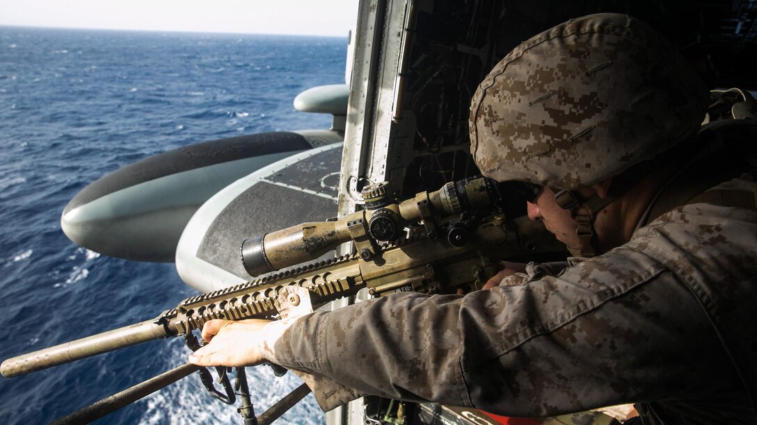 U.S. Marine Cpl. Jakob Stark practices aerial sniping from a CH-53E Super Stallion. Stark is with Weapons Company, 3rd Battalion, 1st Marine Regiment, 15th Marine Expeditionary Unit, The Marines practiced shooting at floating targets in order to improve their marksmanship and become comfortable firing from the air. The 15th MEU is embarked on the Essex Amphibious Ready Group and deployed to maintain regional security in the U.S. 5th Fleet area of operations. 