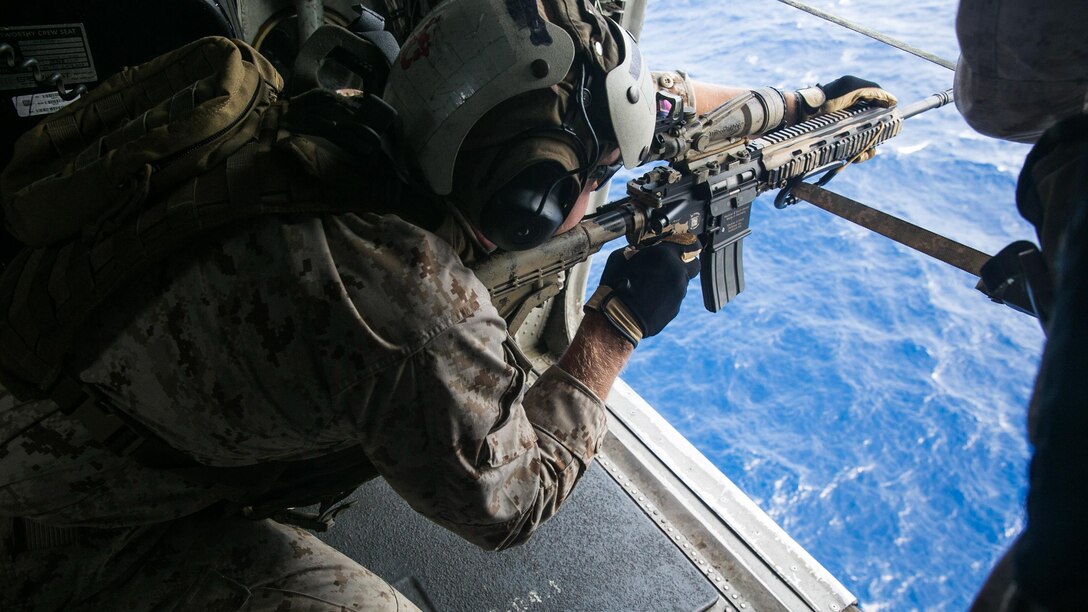 A U.S. Marine with the 15th Marine Expeditionary Unit’s Maritime Raid Force practices aerial sniping from a CH-53E Super Stallion. The Marines practiced shooting at floating targets in order to improve their marksmanship and become comfortable firing from the air. The 15th MEU is embarked on the Essex Amphibious Ready Group and deployed to maintain regional security in the U.S. 5th Fleet area of operations. 