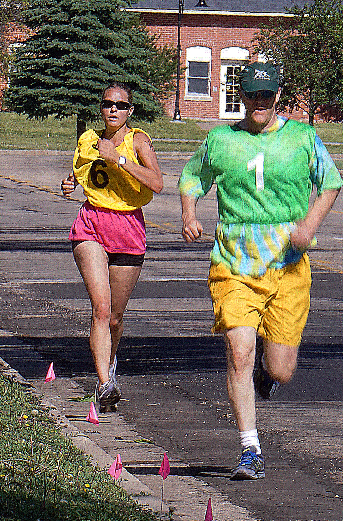 Kristina Penfold races behind Paul Spillman during the 5-kilometer run portion of the 90th Force Support Squadron Mini-Triathlon June 20, 2015. Both Penfold and Spillman completed the triathlon with their spouses. (U.S. Air Force photo by Airman 1st Class Brandon Valle)