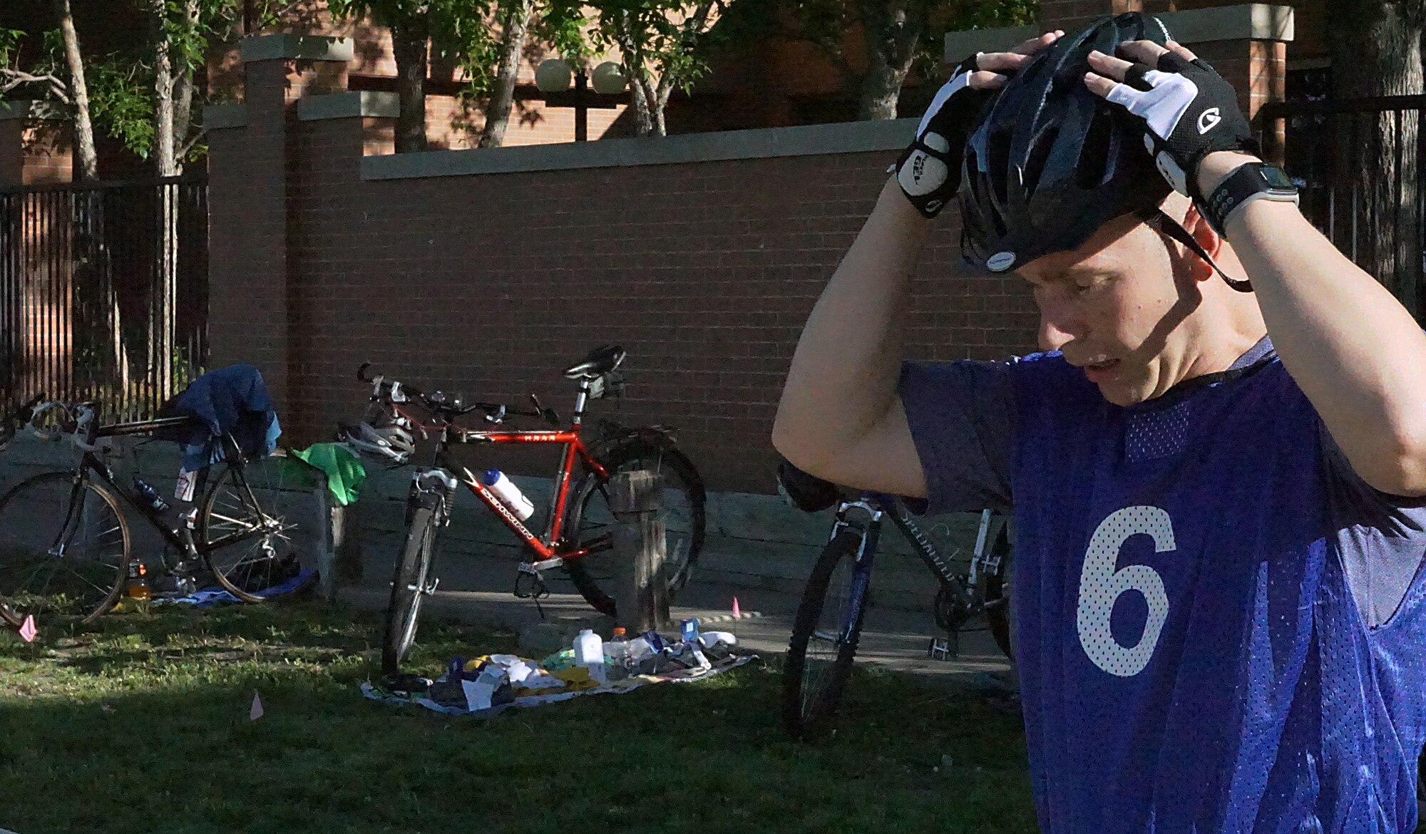 Samuel McClellan puts on his helmet June 20, 2015, before getting on his bike to ride the 10-kilometer bike portion of the 90th Force Support Squadron Mini-Triathlon on F.E. Warren Air Force Base, Wyo. Participants had to jump straight out of the pool and on to their bikes as fast as they could to reduce time between events. (U.S. Air Force photo by Airman 1st Class Brandon Valle)