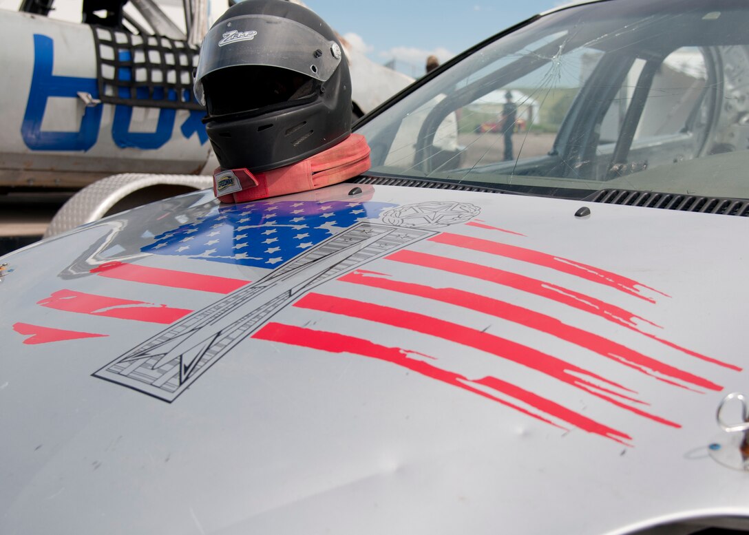 A racing helmet rests on the hood of a stock car in Cheyenne, Wyo., June 13, 2015. The car is belongs to Jeron Schmidt, 13, son of Maj. Neil Copenhaver, 20th Air Force deputy director of logistics. Painted on the hood of the stock car is a missile maintenance badge in front of the U.S. flag. (U.S. Air Force photo by Airman 1st Class Malcolm Mayfield)