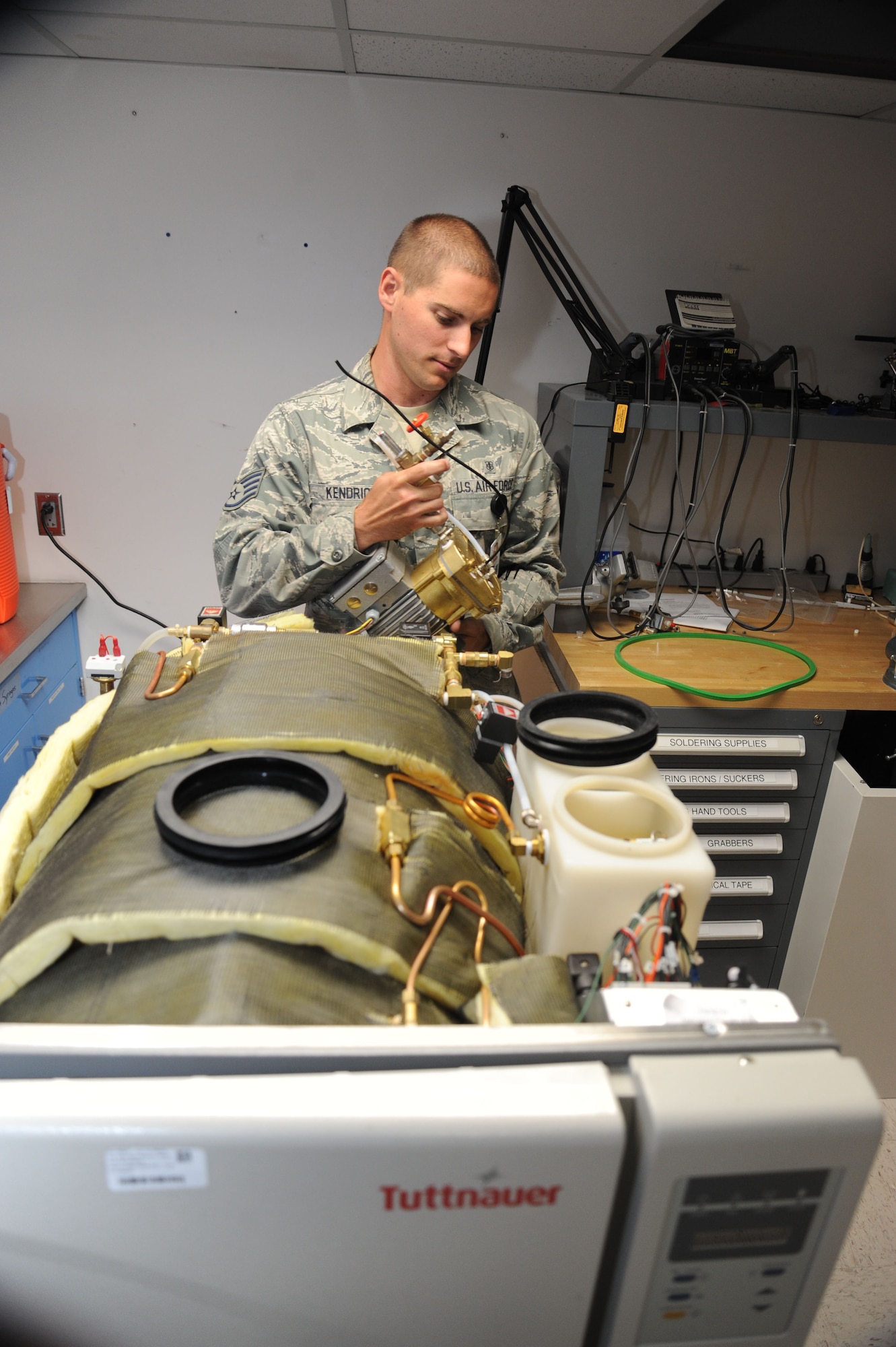 Staff Sgt. Logan Kendrick, 92nd Medical Support Squadron medical maintenance NCO in charge, removes a component of his office’s test dental sterilizer June 18, 2015, at Fairchild Air Force Base, Wash. Dental sterilizers require a complex interplay of electronics, water and steam that makes their repair requirements sophisticated. (U.S. Air Force photo/Senior Airman Sam Fogleman)
