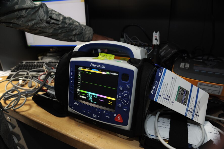 Staff Sgt. Logan Kendrick, 92nd Medical Support Squadron medical maintenance NCO in charge, makes adjustments to a patient simulator as an attached defibrillator occupies the foreground June 18, 2015, at Fairchild Air Force Base, Wash. Defibrillators are one of the most commonly tested and critical medical devices at the base. (U.S. Air Force photo/Senior Airman Sam Fogleman)