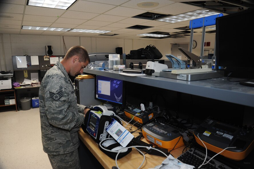 Staff Sgt. Logan Kendrick, 92nd Medical Support Squadron medical maintenance NCO in charge, connects a defibrillator to patient simulators June 18, 2015, at Fairchild Air Force Base, Wash. Kendrick’s office is responsible for maintaining standards of medical equipment used at the base. (U.S. Air Force photo/Senior Airman Sam Fogleman)