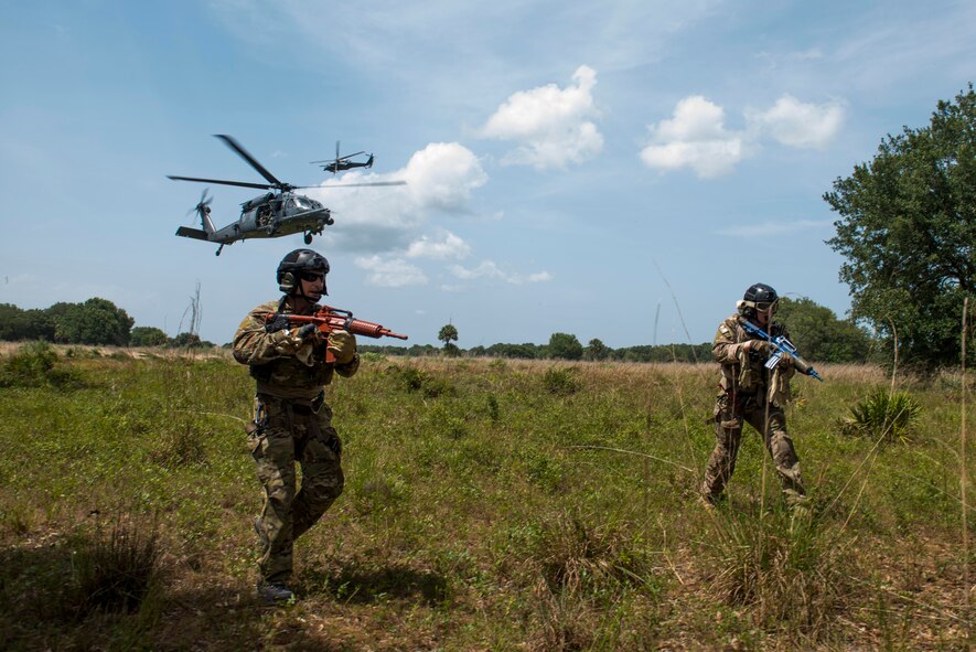 Pararescuemen from the 920th Rescue Wing, Patrick Air Force Base, Fla., arrive on-scene for a simulated personnel recovery scenario during Exercise DRAGON STRIKE June 11, 2015, near Avon Park Air Force Range, Fla. HH-60G Pave Hawk pilots coordinated with A-10C Thunderbolt II pilots on the injured personnel’s location. (U.S. Air Force photo by Airman 1st Class Dillian Bamman/Released)