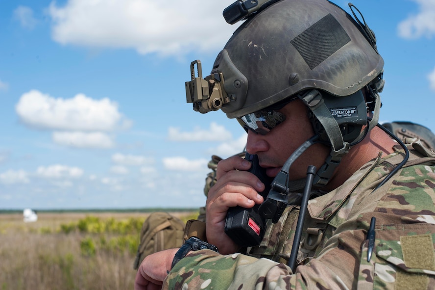 U.S. Army Sgt. 1st Class Joel Sobrado, 3d Infantry Division fire support NCO, calls out GPS coordinates to 3-27th Field Artillery Regiment soldiers during Exercise DRAGON STRIKE June 9, 2015, at Avon Park Air Force Range, Fla. Sobrado and 18th Air Support Operations Group joint terminal attack controllers coordinated with the soldiers on launch locations for M142 High Mobility Artillery Rocket System rockets. (U.S. Air Force photo by Airman 1st Class Dillian Bamman/Released)