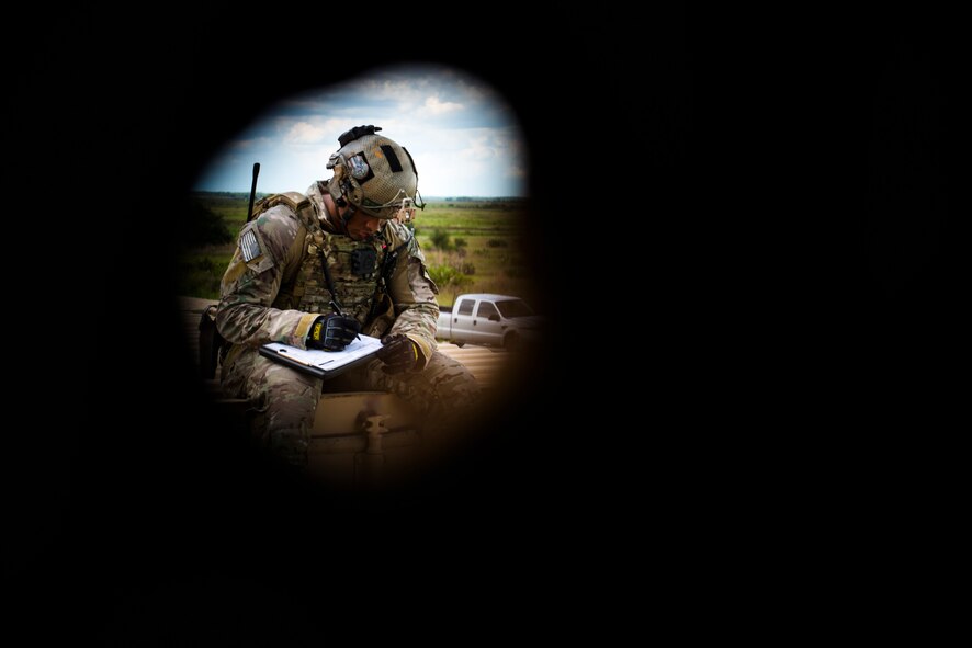 U.S. Air Force Staff Sgt. Cruz Richardson, 18th Air Support Operations Group joint terminal attack controller (JTAC) team leader, evaluates JTAC coordinates for accuracy during Exercise DRAGON STRIKE June 9, 2015, at Avon Park Air Force Range, Fla. Richardson evaluated his Airmen on their ability to coordinate airstrike targets efficiently and from a safe distance away from friendlies. (U.S. Air Force photo by Airman 1st Class Dillian Bamman/Released)