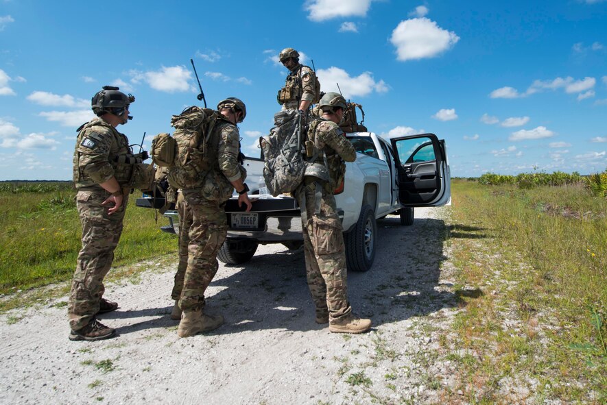 Joint terminal attack controllers (JTACs) from the 18th Air Support Operations Group prepare equipment before a M142 High Mobility Artillery Rocket System (HIMARS) launch during Exercise DRAGON STRIKE June 9, 2015, at Avon Park Air Force Range, Fla. JTACs aided in A-10 strafe runs and personnel recovery missions in addition to the HIMARS launches for DRAGON STRIKE. (U.S. Air Force photo by Airman 1st Class Dillian Bamman/Released)