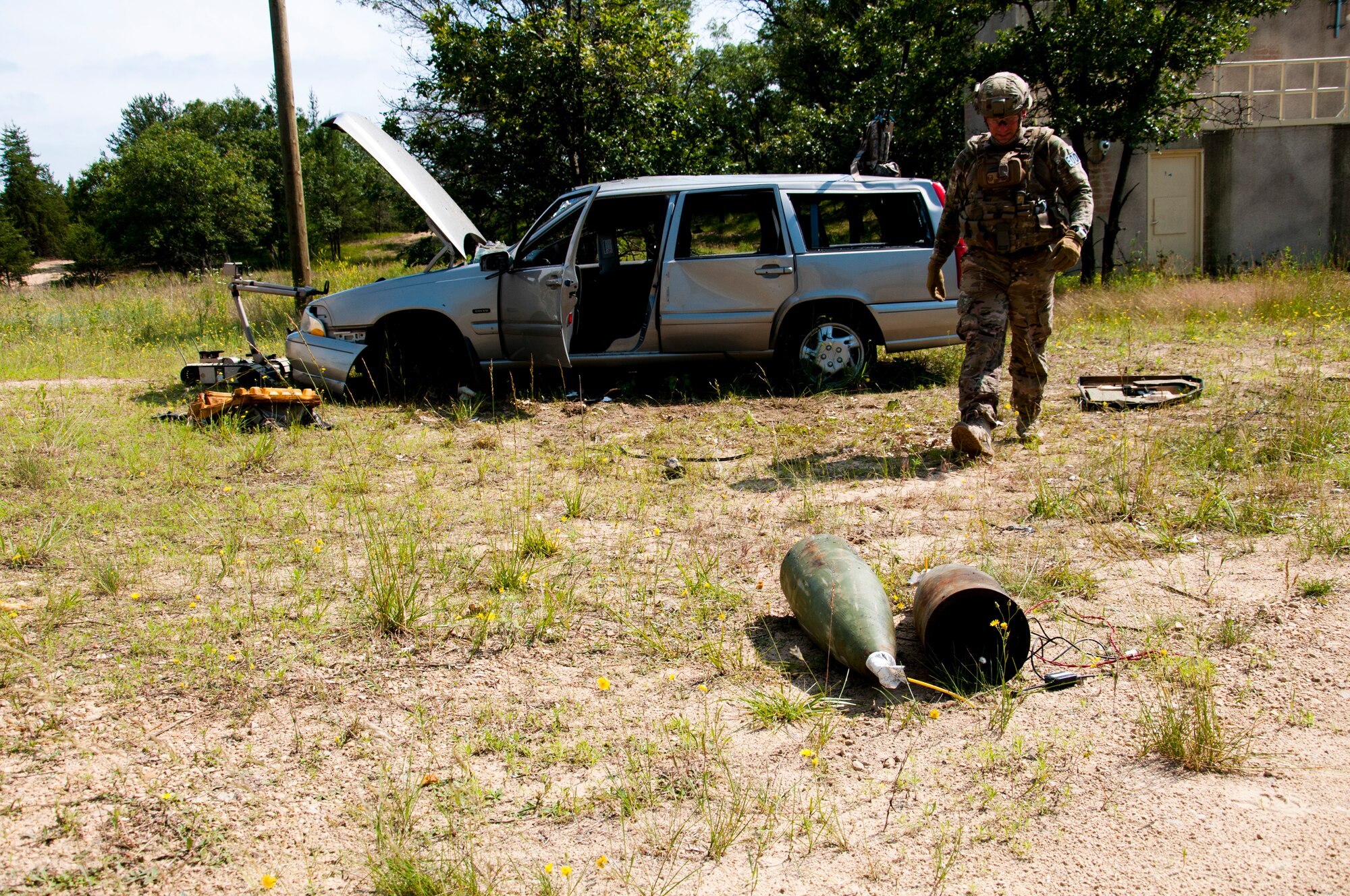 MSgt. Shawn Lundgren, 446th Civil Engineer Squadron explosive ordnance disposal technician, removes a simulated improvised explosive device after neutralizing it during the Patriot Warrior exercise at Fort McCoy, Wis., June 21, 2015. Patriot Warrior is a joint exercise designed to demonstrate contingency deployment training ranging from bare base buildup to full operational capabilities. It supports Exercise Global Lightning, a Combat Support Training Exercise (CSTX) including Global Medic 15 and Quartermaster Liquid Logistics Exercise 15 (QLLEX). Over 6,000 members from U.S. service components including Air Force, Army, and Navy (Active, Guard, and Reserve) participated alongside British and Canadian forces. (U.S. Air Force photo by Senior Airman Daniel Liddicoet/Released)