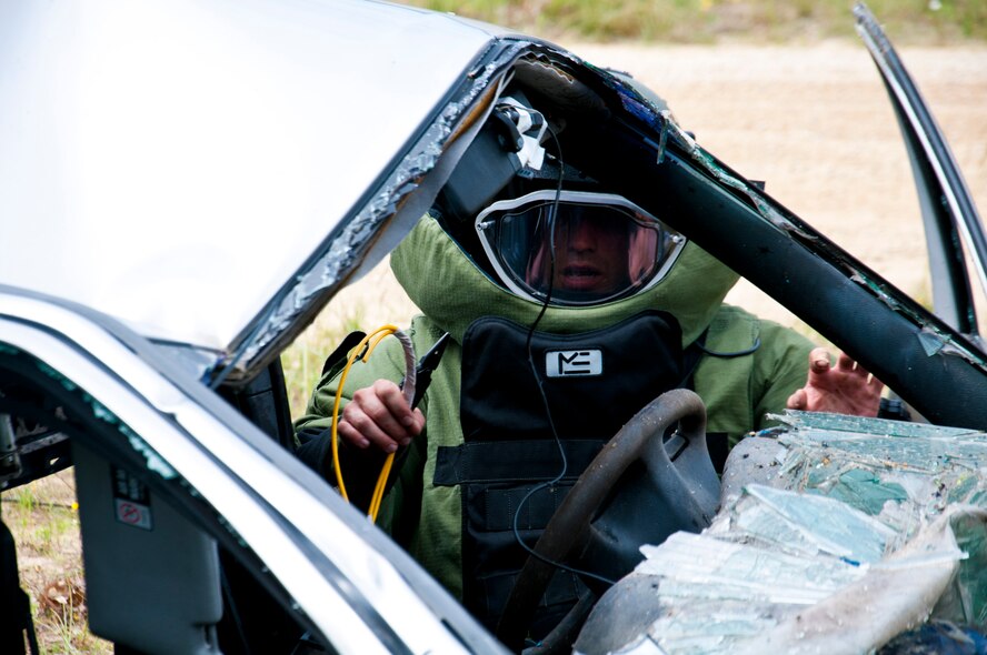 MSgt. Shawn Lundgren, 446th Civil Engineer Squadron explosive ordnance disposal technician attempts to dismantle a simulated improvised explosive device during the Patriot Warrior exercise at Fort McCoy, Wis., June 21, 2015. Patriot Warrior is a joint exercise designed to demonstrate contingency deployment training ranging from bare base buildup to full operational capabilities. It supports Exercise Global Lightning, a Combat Support Training Exercise (CSTX) including Global Medic 15 and Quartermaster Liquid Logistics Exercise 15 (QLLEX). Over 6,000 members from U.S. service components including Air Force, Army, and Navy (Active, Guard, and Reserve) participated alongside British and Canadian forces. (U.S. Air Force photo by Senior Airman Daniel Liddicoet/Released)