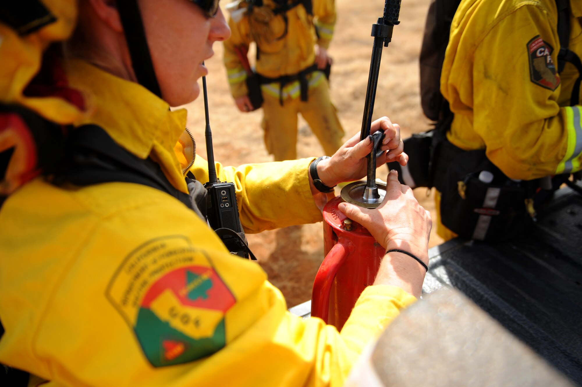 CAL Fire Department firefighters prepare torches to ignite fields for a controlled fire June 17, 2015 at Beale Air Force Base, California. The burn consumed approximately 800 acres in an effort to renew cattle grazing land and control vegetation growth. (U.S. Air Force photo by Preston L. Cherry)