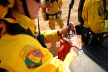CAL Fire Department firefighters prepare torches to ignite fields for a controlled fire June 17, 2015 at Beale Air Force Base, California. The burn consumed approximately 800 acres in an effort to renew cattle grazing land and control vegetation growth. (U.S. Air Force photo by Preston L. Cherry)