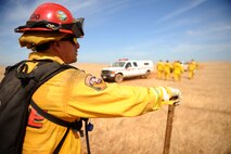 Tony Dorado, CAL Fire Department fire captain B, scans the area during a controlled fire at Beale Air Force Base on June 17, 2015. The burn consumed approximately 800 acres in an effort to renew cattle grazing land and control vegetation growth. (U.S. Air Force photo by Preston L. Cherry)