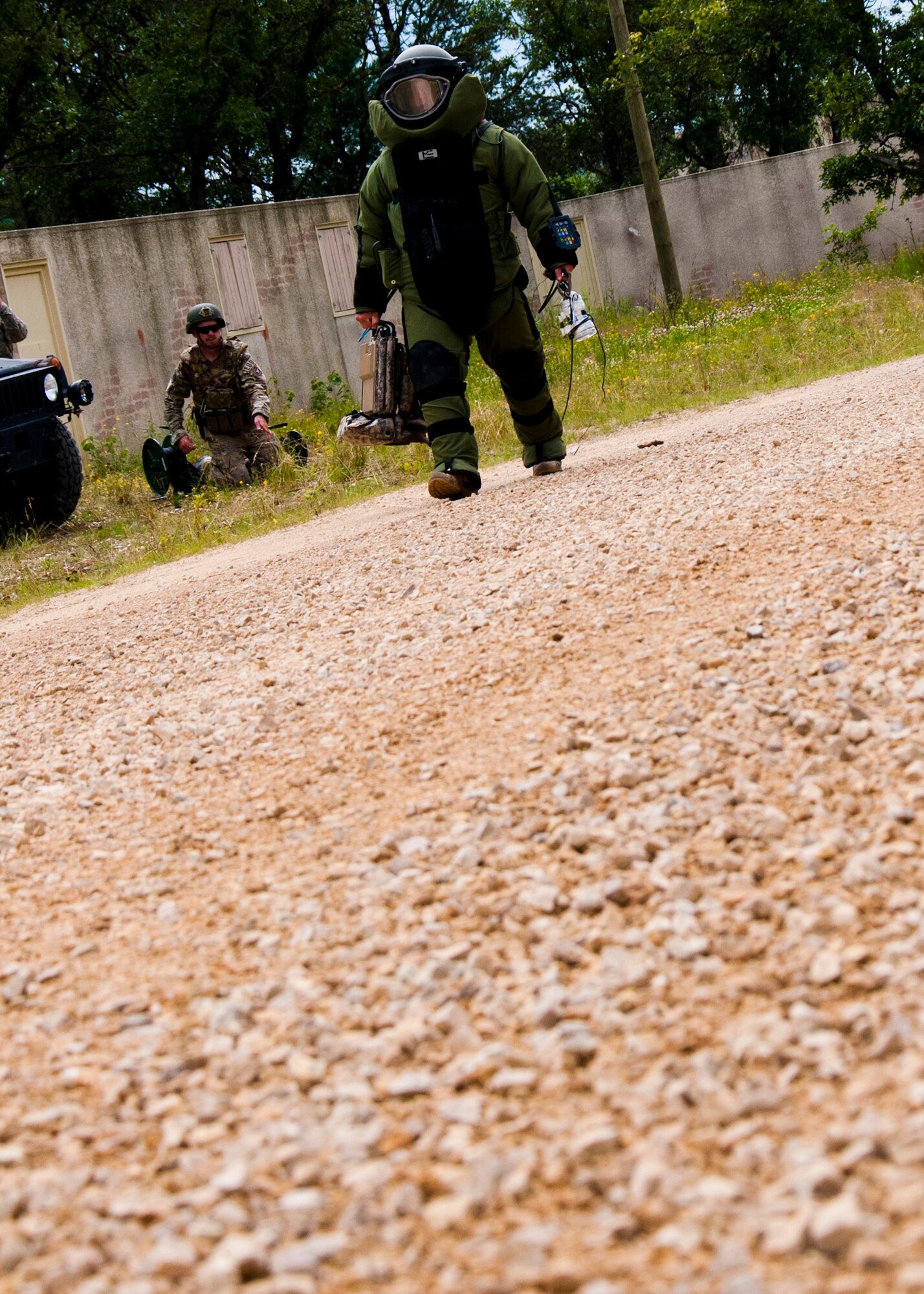 MSgt. Shawn Lundgren, 446th Civil Engineer Squadron explosive ordnance disposal technician approaches a simulated improvised explosive device in a bomb suit during the Patriot Warrior exercise at Fort McCoy, Wis., June 21, 2015. Patriot Warrior is a joint exercise designed to demonstrate contingency deployment training ranging from bare base buildup to full operational capabilities. It supports Exercise Global Lightning, a Combat Support Training Exercise (CSTX) including Global Medic 15 and Quartermaster Liquid Logistics Exercise 15 (QLLEX). Over 6,000 members from U.S. service components including Air Force, Army, and Navy (Active, Guard, and Reserve) participated alongside British and Canadian forces. (U.S. Air Force photo by Senior Airman Daniel Liddicoet/Released)
