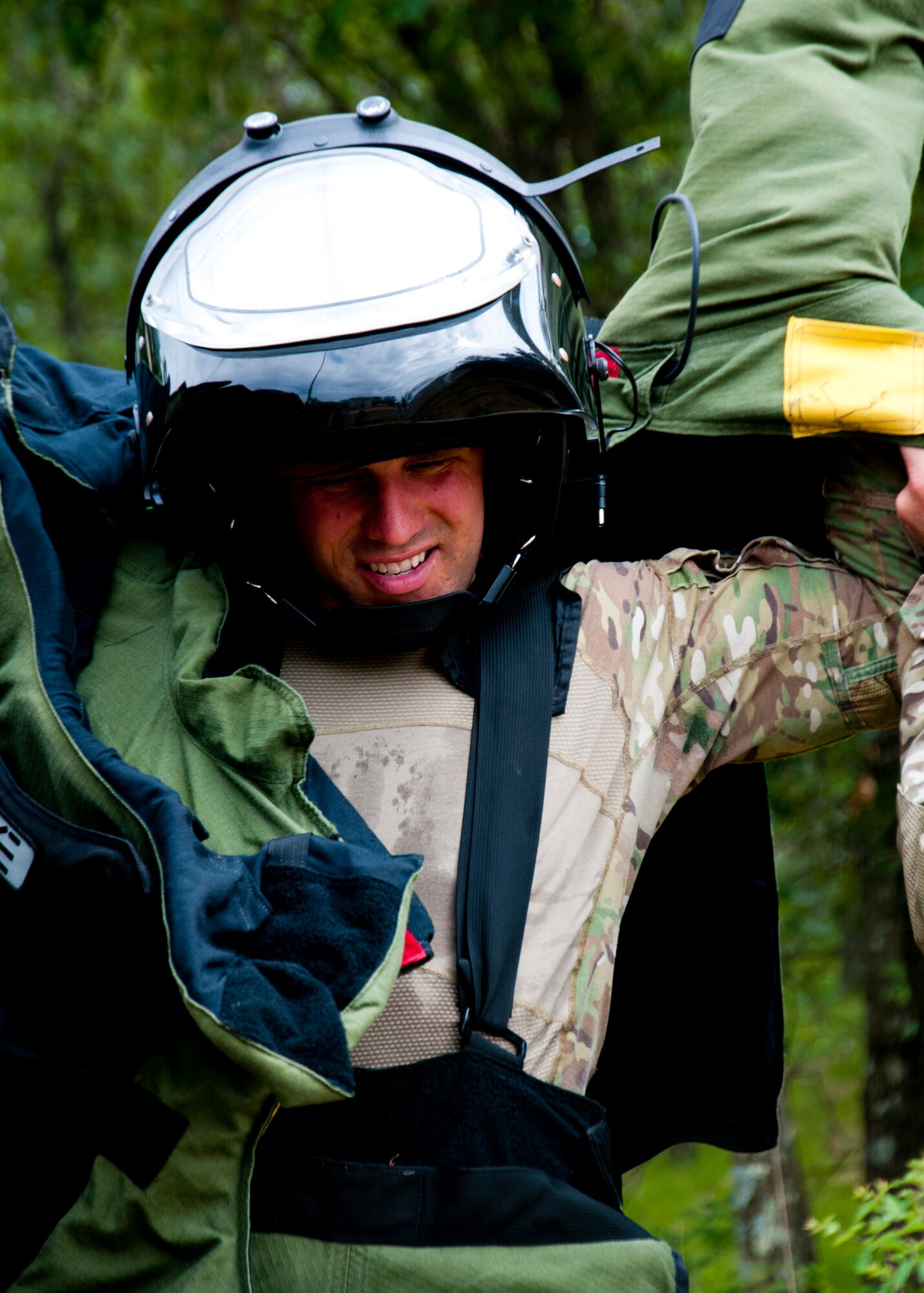 MSgt. Shawn Lundgren, 446th Civil Engineer Squadron explosive ordnance disposal technician gets into a bomb suit to remove a simulated improvised explosive device during the Patriot Warrior exercise at Fort McCoy, Wis., June 21, 2015. Patriot Warrior is a joint exercise designed to demonstrate contingency deployment training ranging from bare base buildup to full operational capabilities. It supports Exercise Global Lightning, a Combat Support Training Exercise (CSTX) including Global Medic 15 and Quartermaster Liquid Logistics Exercise 15 (QLLEX). Over 6,000 members from U.S. service components including Air Force, Army, and Navy (Active, Guard, and Reserve) participated alongside British and Canadian forces. (U.S. Air Force photo by Senior Airman Daniel Liddicoet/Released)
