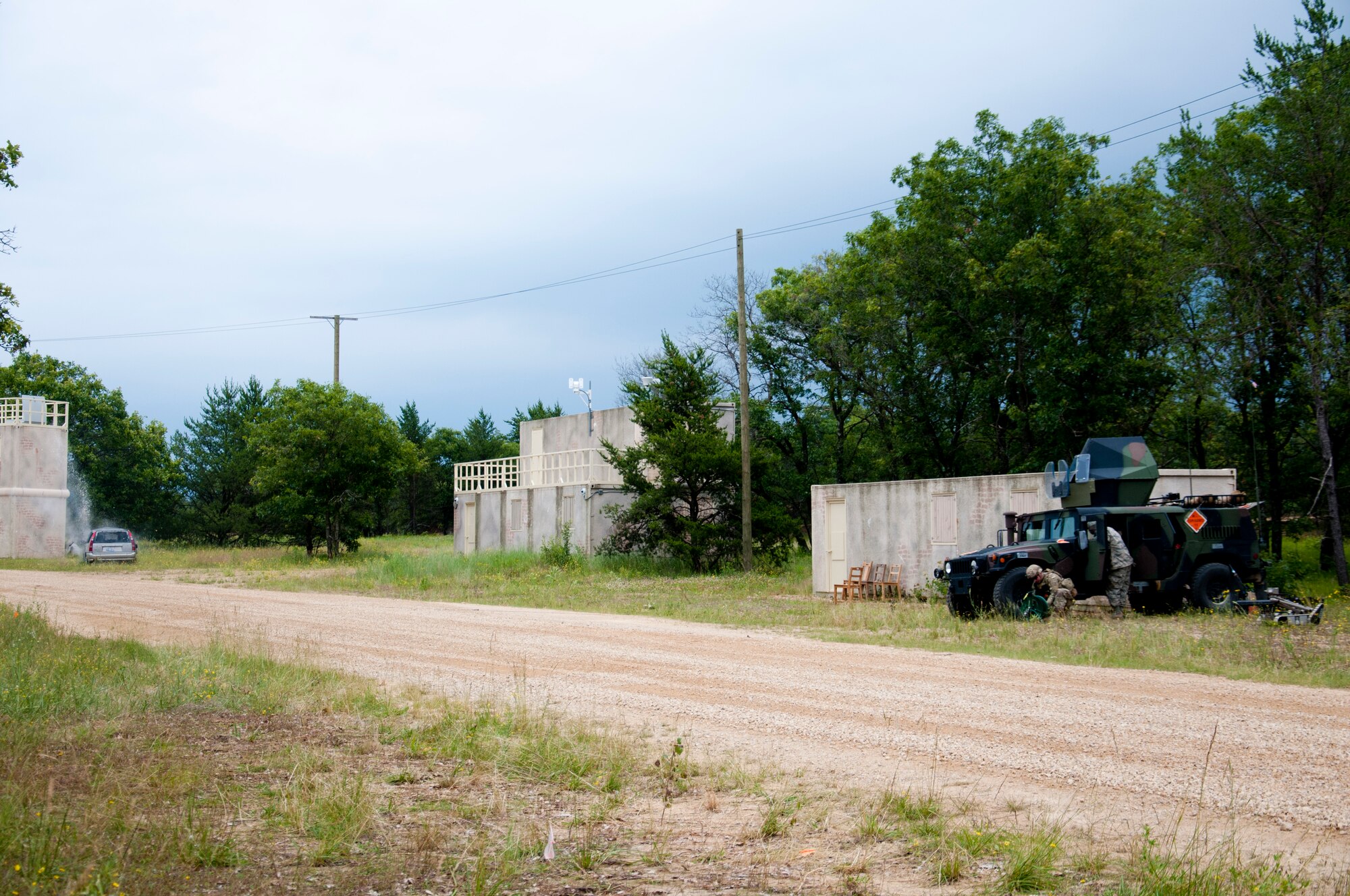 U.S. Air Force explosive ordnance disposal technicians detonate a charge to neutralize a simulated improvised explosive device during the Patriot Warrior exercise at Fort McCoy, Wis., June 21, 2015. Patriot Warrior is a joint exercise designed to demonstrate contingency deployment training ranging from bare base buildup to full operational capabilities. It supports Exercise Global Lightning, a Combat Support Training Exercise (CSTX) including Global Medic 15 and Quartermaster Liquid Logistics Exercise 15 (QLLEX). Over 6,000 members from U.S. service components including Air Force, Army, and Navy (Active, Guard, and Reserve) participated alongside British and Canadian forces. (U.S. Air Force photo by Senior Airman Daniel Liddicoet/Released)