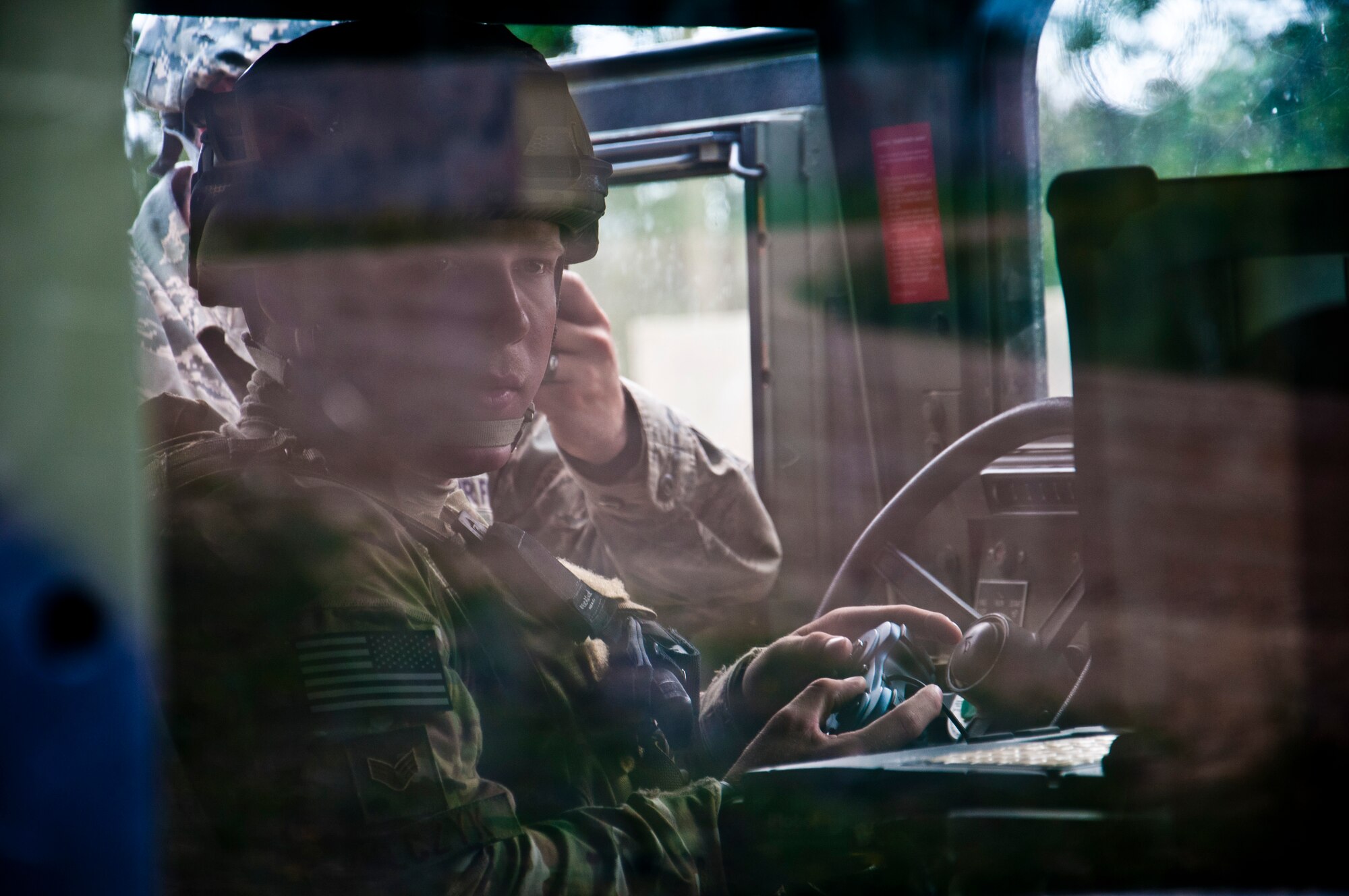 Senior Airman Joseph Kulczyk, 914th Civil Engineer Squadron, explosive ordnance disposal technician, controls a robot using a remote controller to inspect a car containing an improvised explosive device during the Patriot Warrior exercise at Fort McCoy, Wis., June 21, 2015. Patriot Warrior is a joint exercise designed to demonstrate contingency deployment training ranging from bare base buildup to full operational capabilities. It supports Exercise Global Lightning, a Combat Support Training Exercise (CSTX) including Global Medic 15 and Quartermaster Liquid Logistics Exercise 15 (QLLEX). Over 6,000 members from U.S. service components including Air Force, Army, and Navy (Active, Guard, and Reserve) participated alongside British and Canadian forces. (U.S. Air Force photo by Senior Airman Daniel Liddicoet/Released)