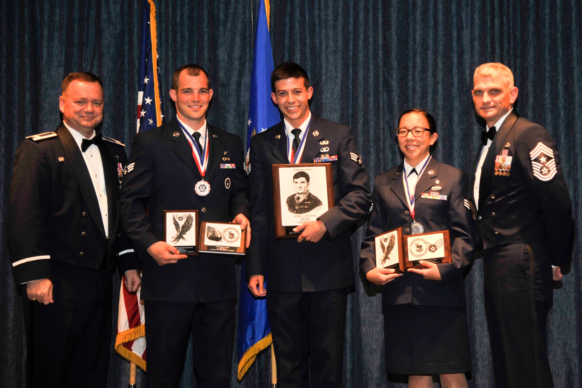The distinguished graduates from Airman Leadership School Class 15-E pose with Col. Brian McDaniel, 92nd Air Refueling Wing commander, and Chief Master Sgt. Christian Pugh, 92nd ARW command chief, June 18, 2015, at Fairchild Air Force Base, Wash. ALS is a five-week course that develops Airmen into supervisors and focuses on leadership abilities, profession of arms and effective communication in the workplace. (U.S. Air Force photo/Airman 1st Class Taylor Bourgeous)
