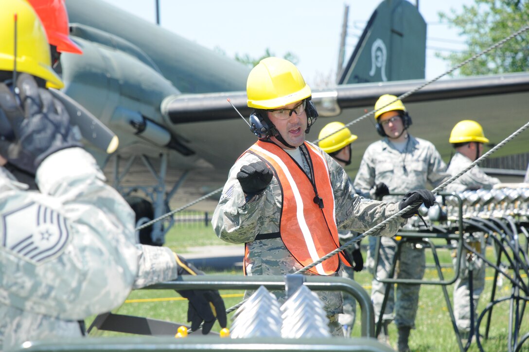 Tech. Sgt. Norman Green, 914th Maintenance Squadron, Crash Damaged and Disabled Aircraft Recover Team Chief, verifies air pressure with members of the CDDAR team at Niagara Falls Air Reserve Station on June 6, 2015. Green led a team of more than 20 personnel through a simulated crash and recovery exercise. (U.S. Air Force photo by Staff Sgt. Matthew Burke)